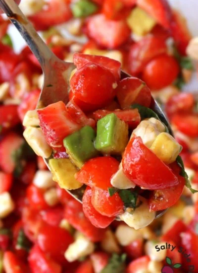 strawberry caprese salad on a spoon.