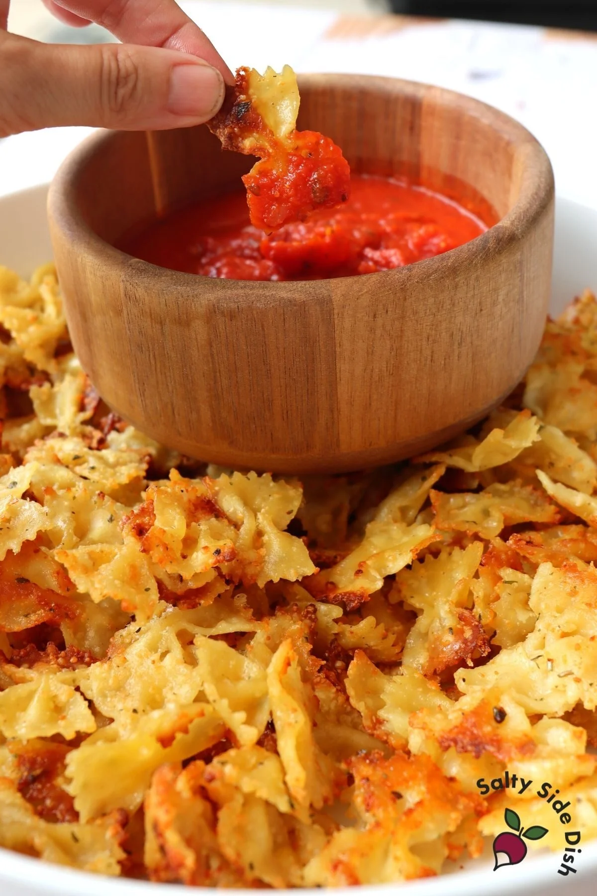 dipping pasta into marinara sauce.