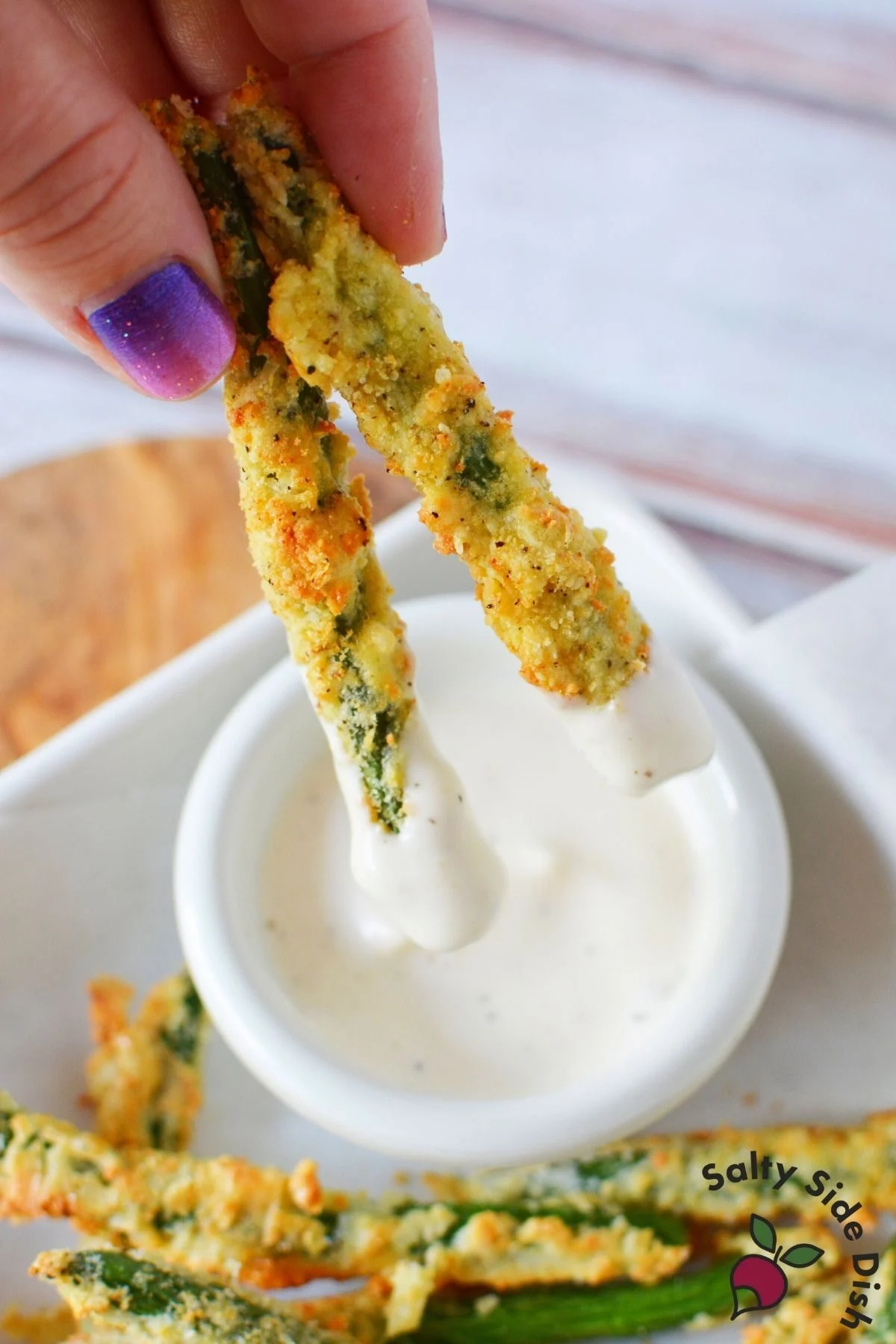 air fried green beans dipping in ranch dressing.