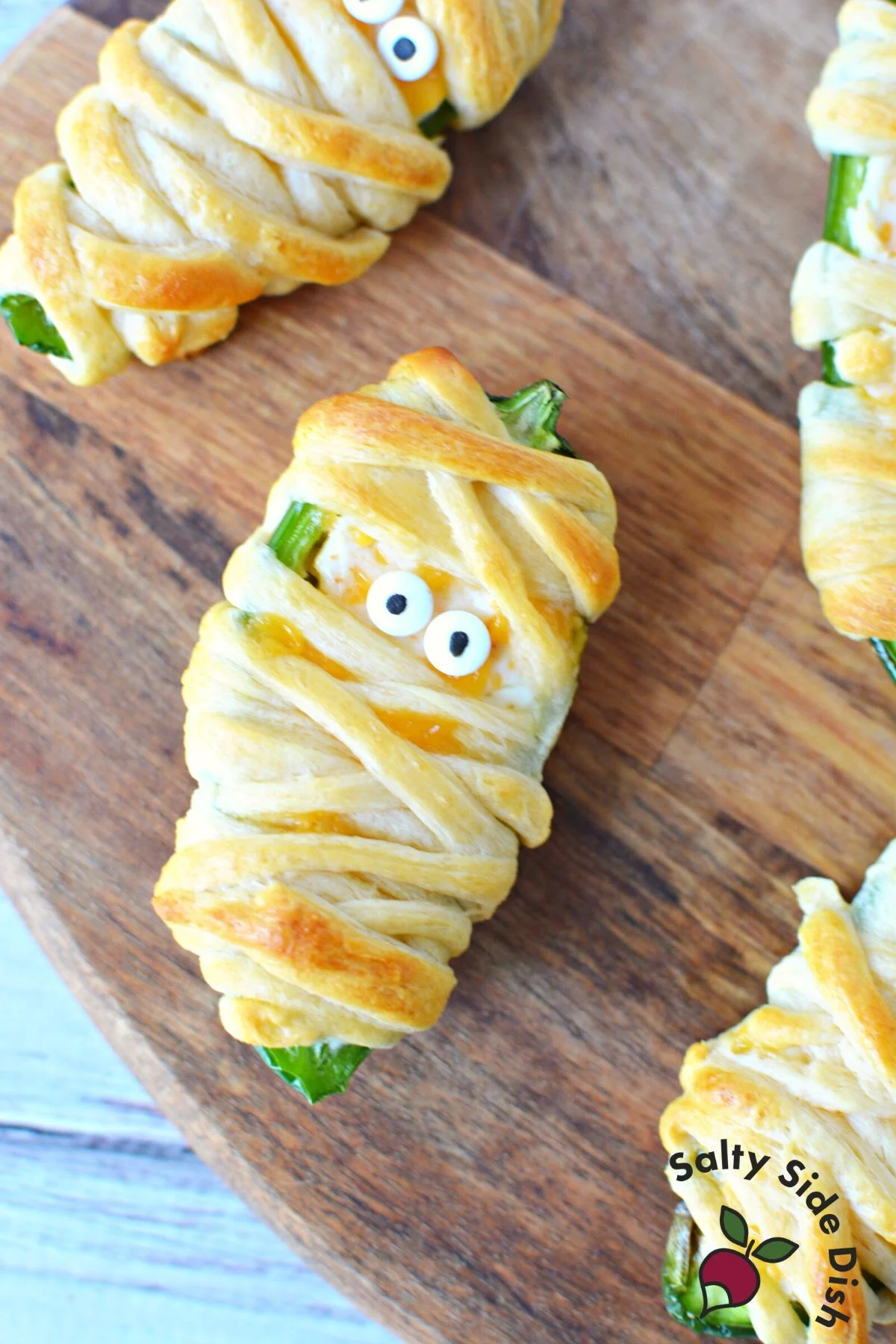 jalapeno cream cheese stuffed poppers wrapped like mummys.