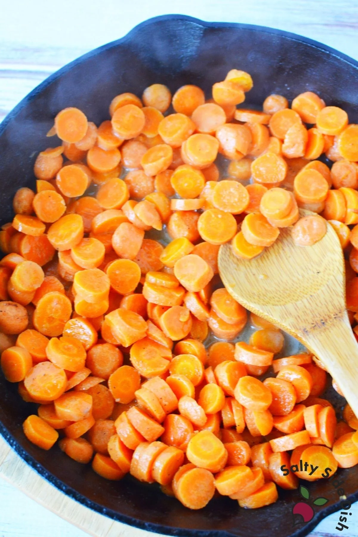sautéed carrots in a cast iron pan.