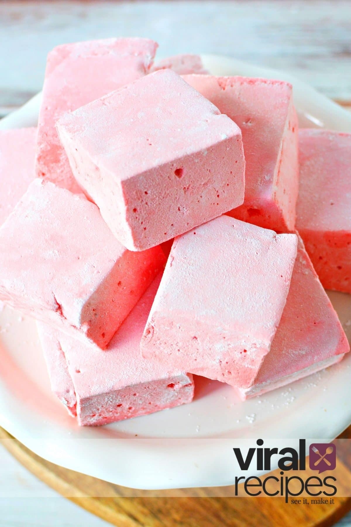 stacked homemade marshmallows on a white plate.