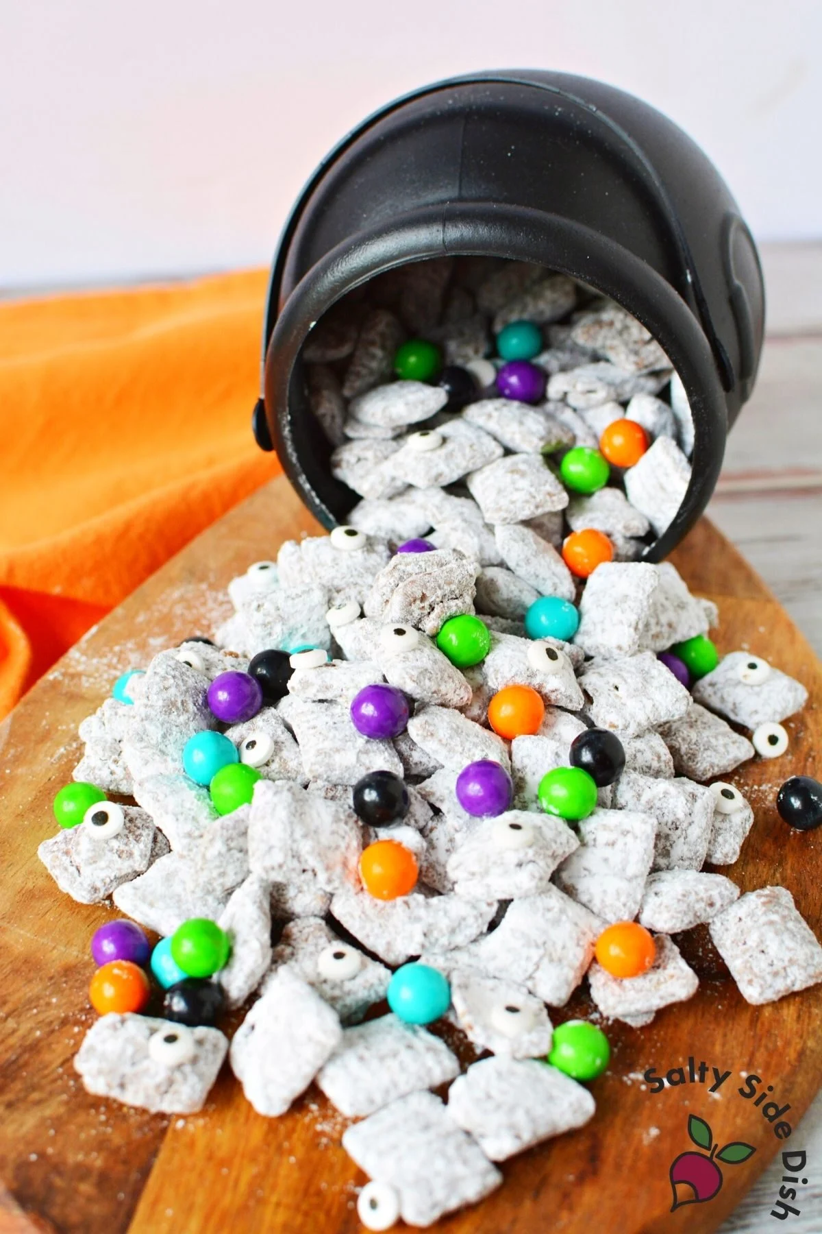 muddy buddies spilling out of a mini cauldron.