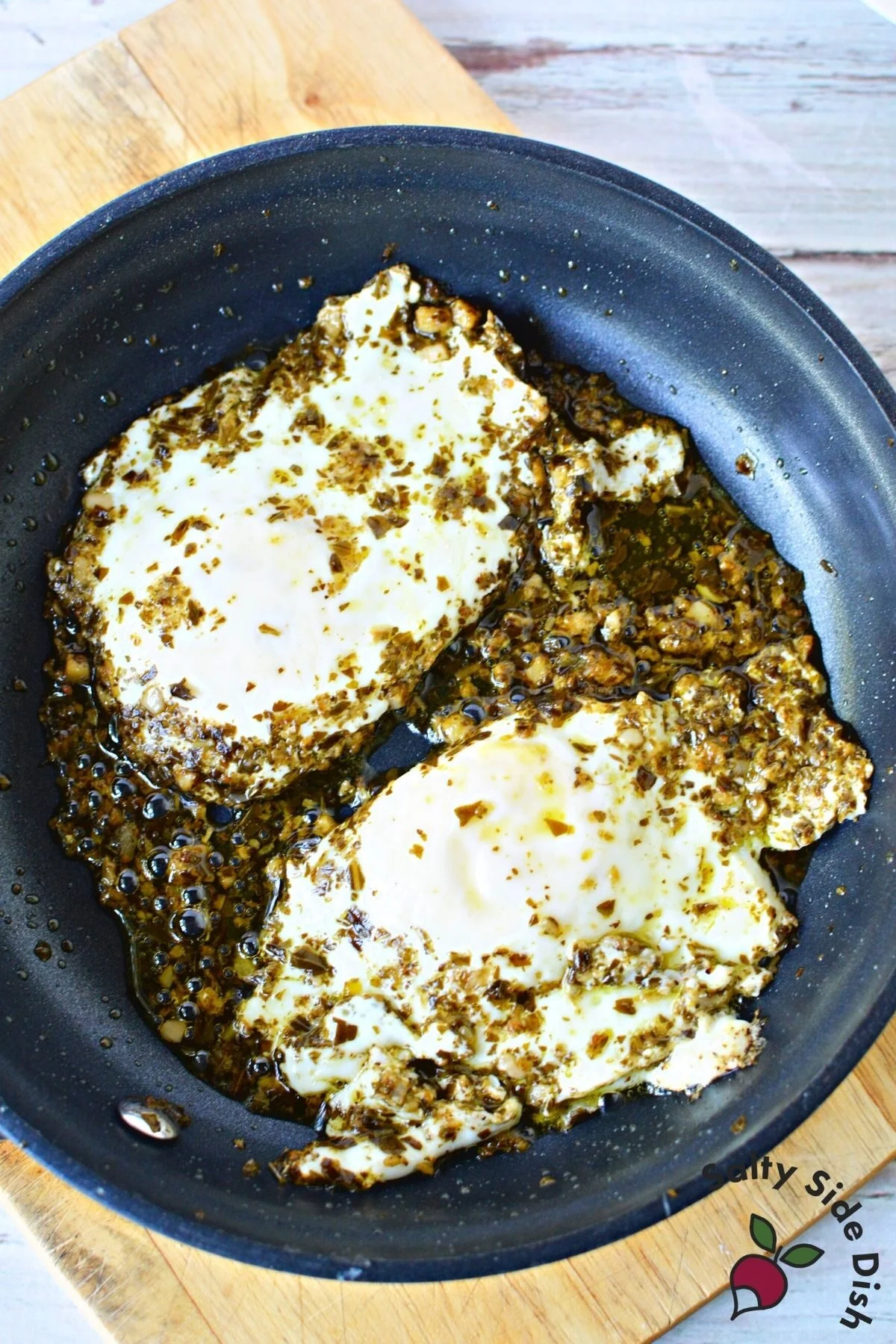 pesto eggs in a skillet.