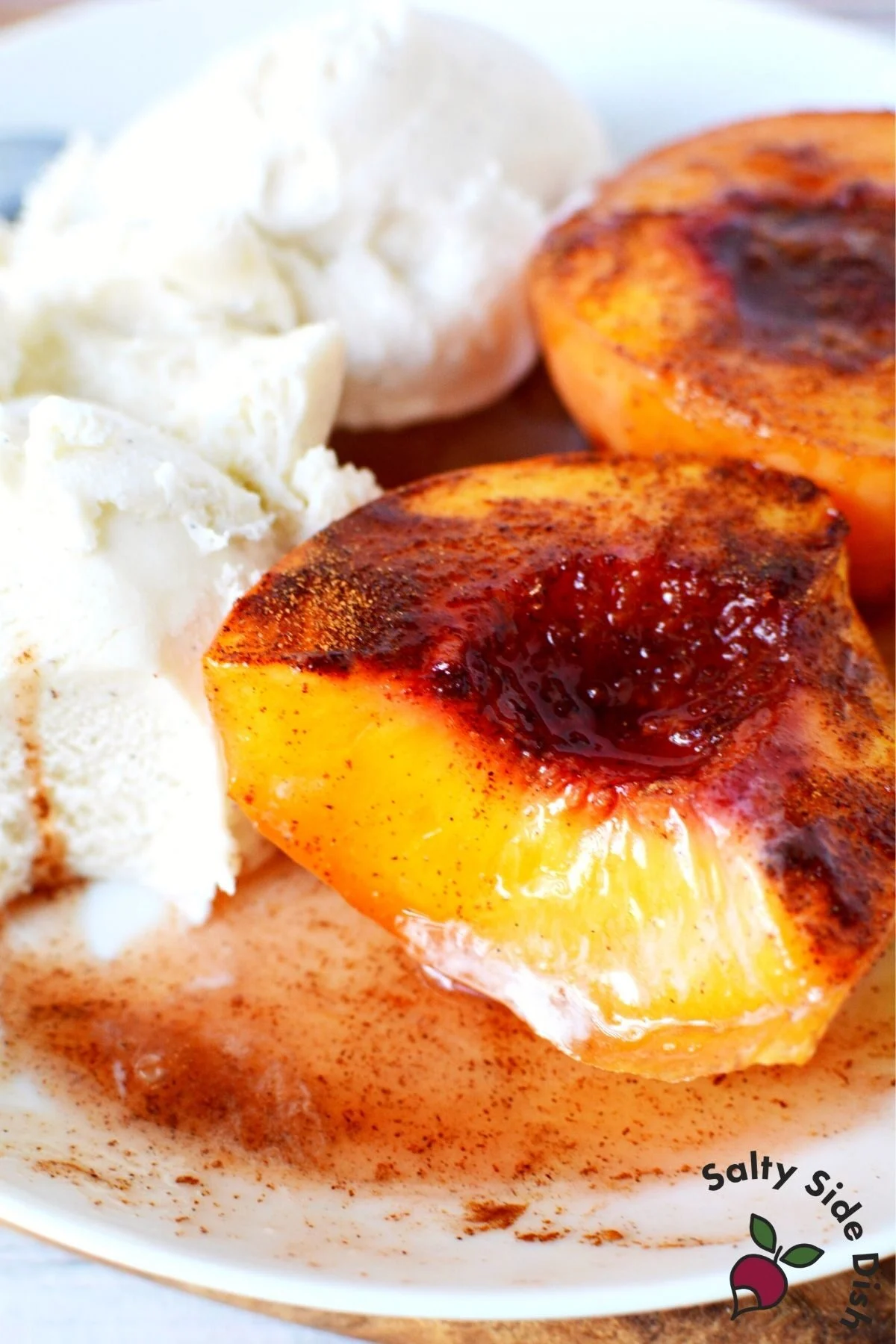 air fryer peaches on a plate with ice cream.