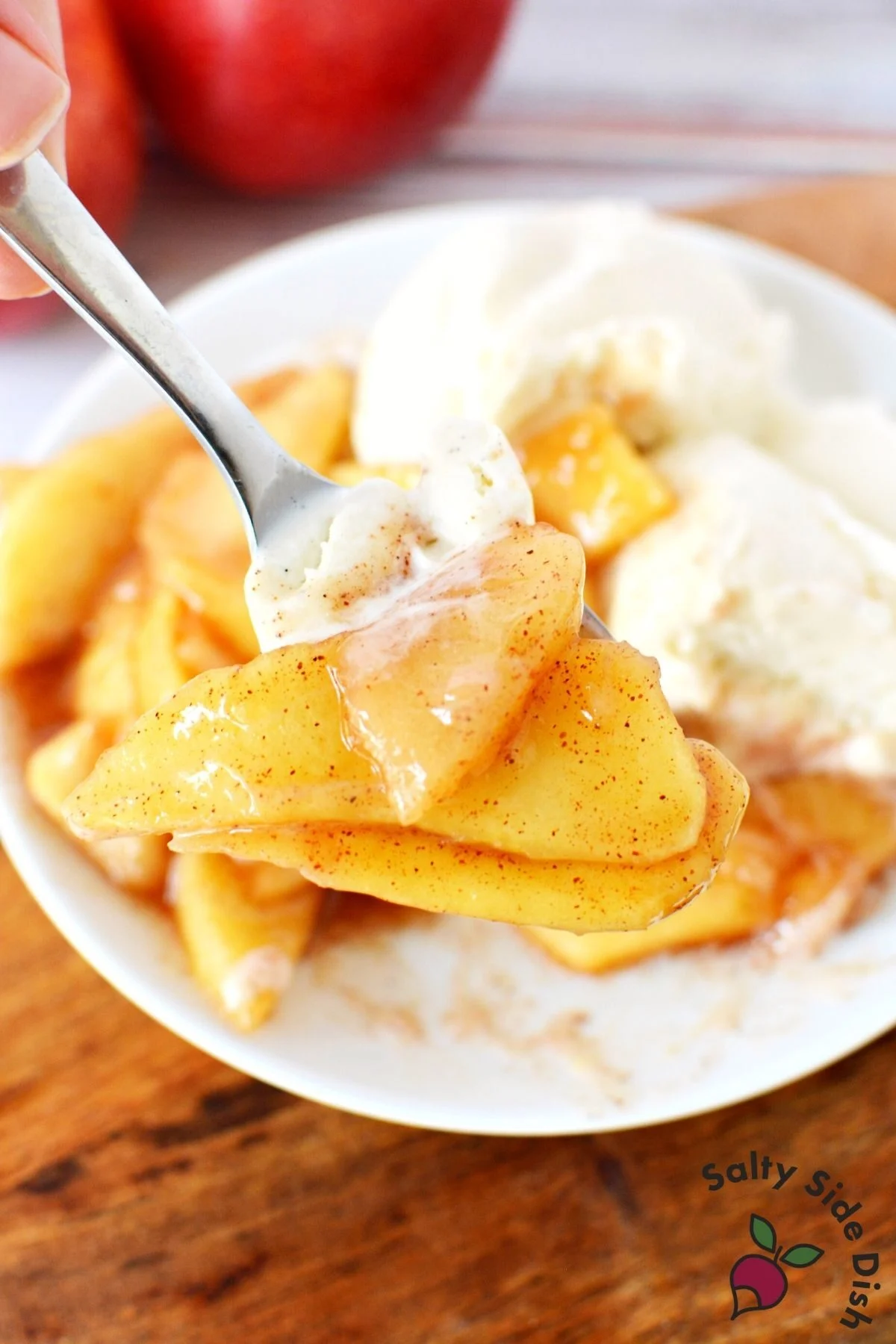 apple pie filling on a plate with ice cream.