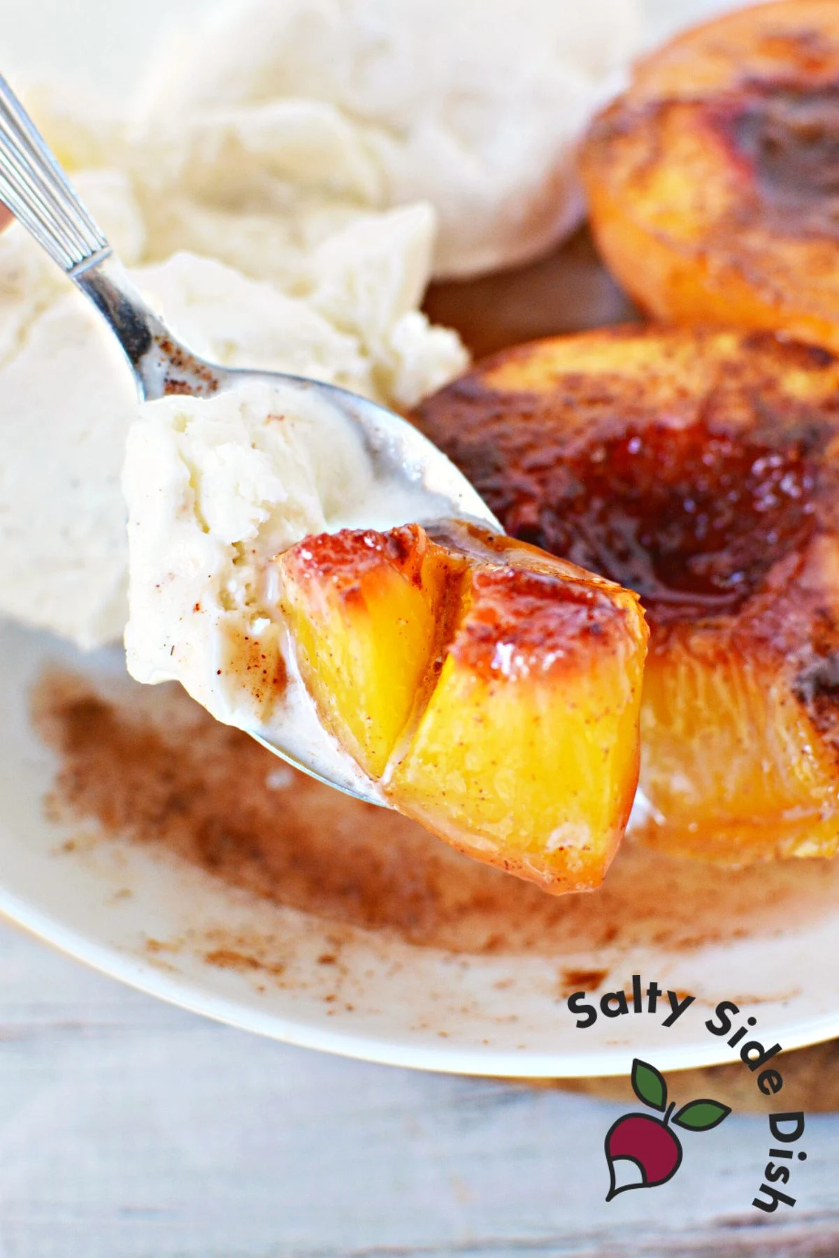 bite of a peach with ice cream on a fork.