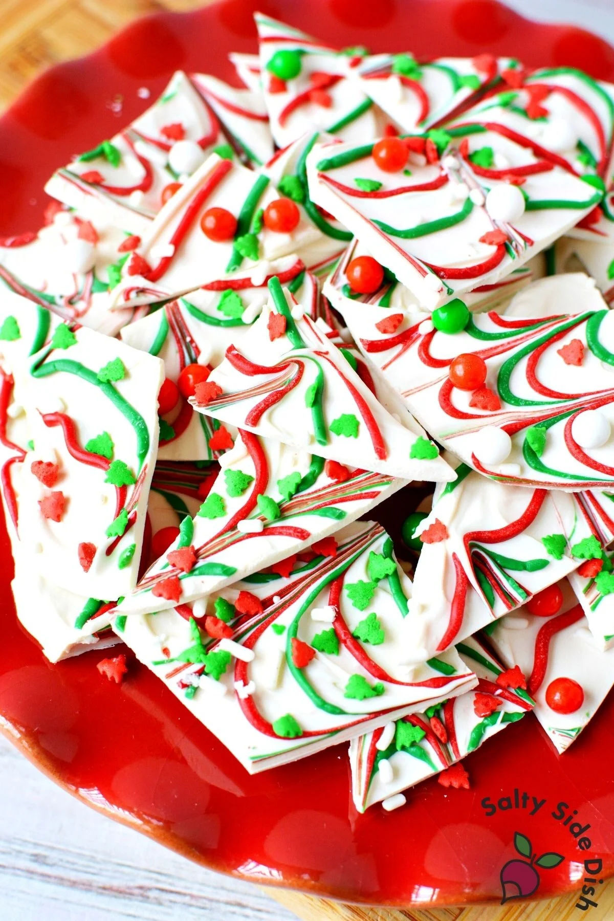 white chocolate christmas bark on a red plate.