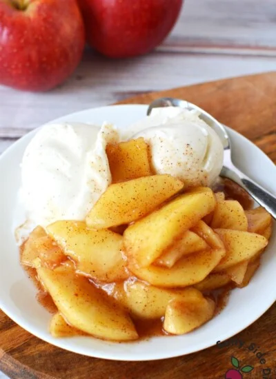 white plate with apple pie filling and ice cream.