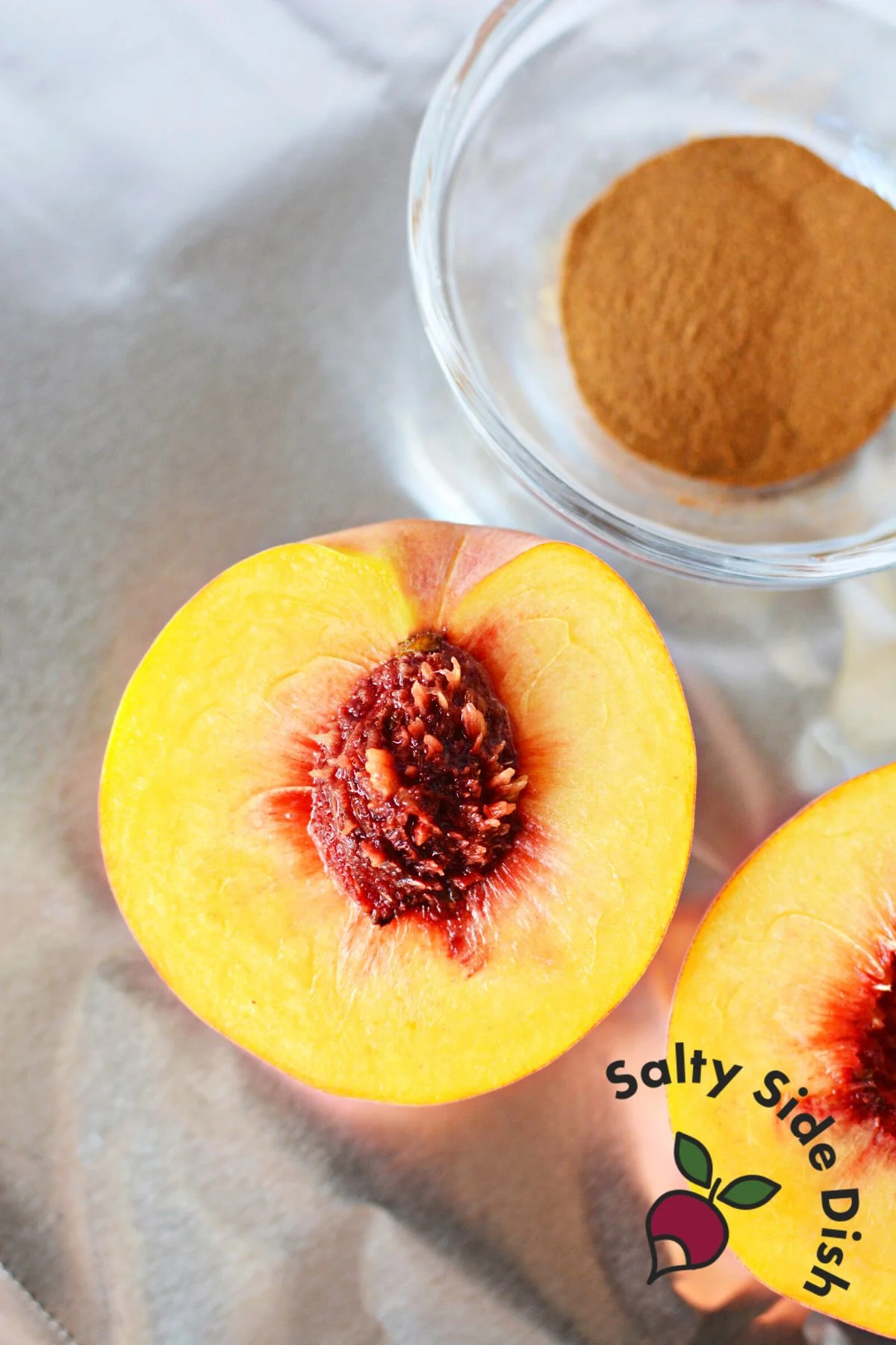half cut white peach with pit showing.