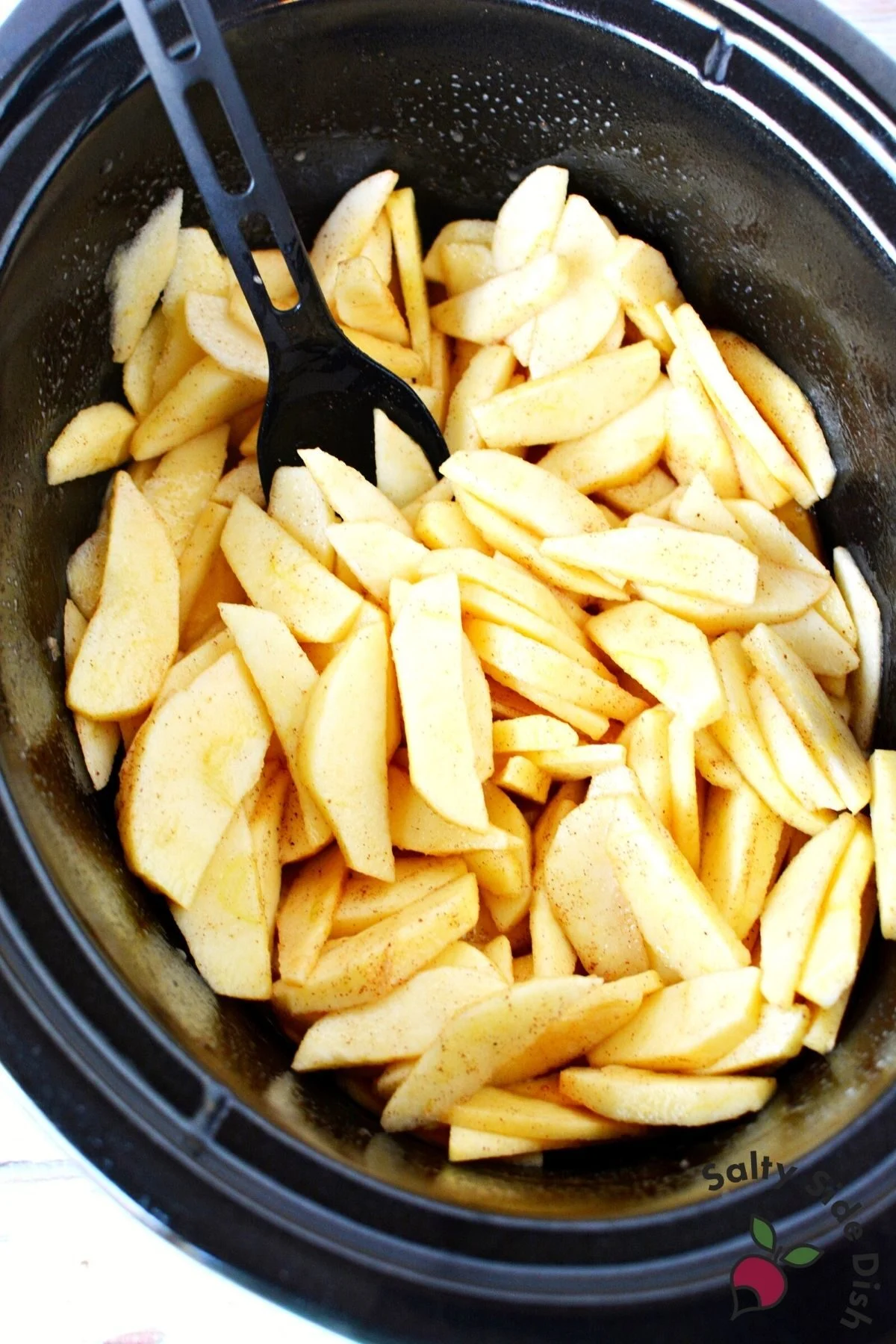 sliced apples in a crock pot.