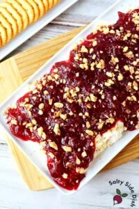 whipped feta cranberry dip with walnuts on a plate.