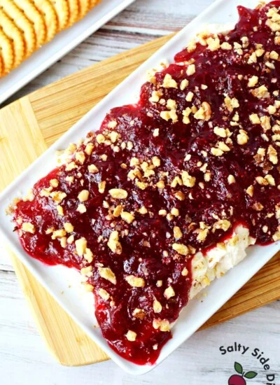 whipped feta cranberry dip with walnuts on a plate.
