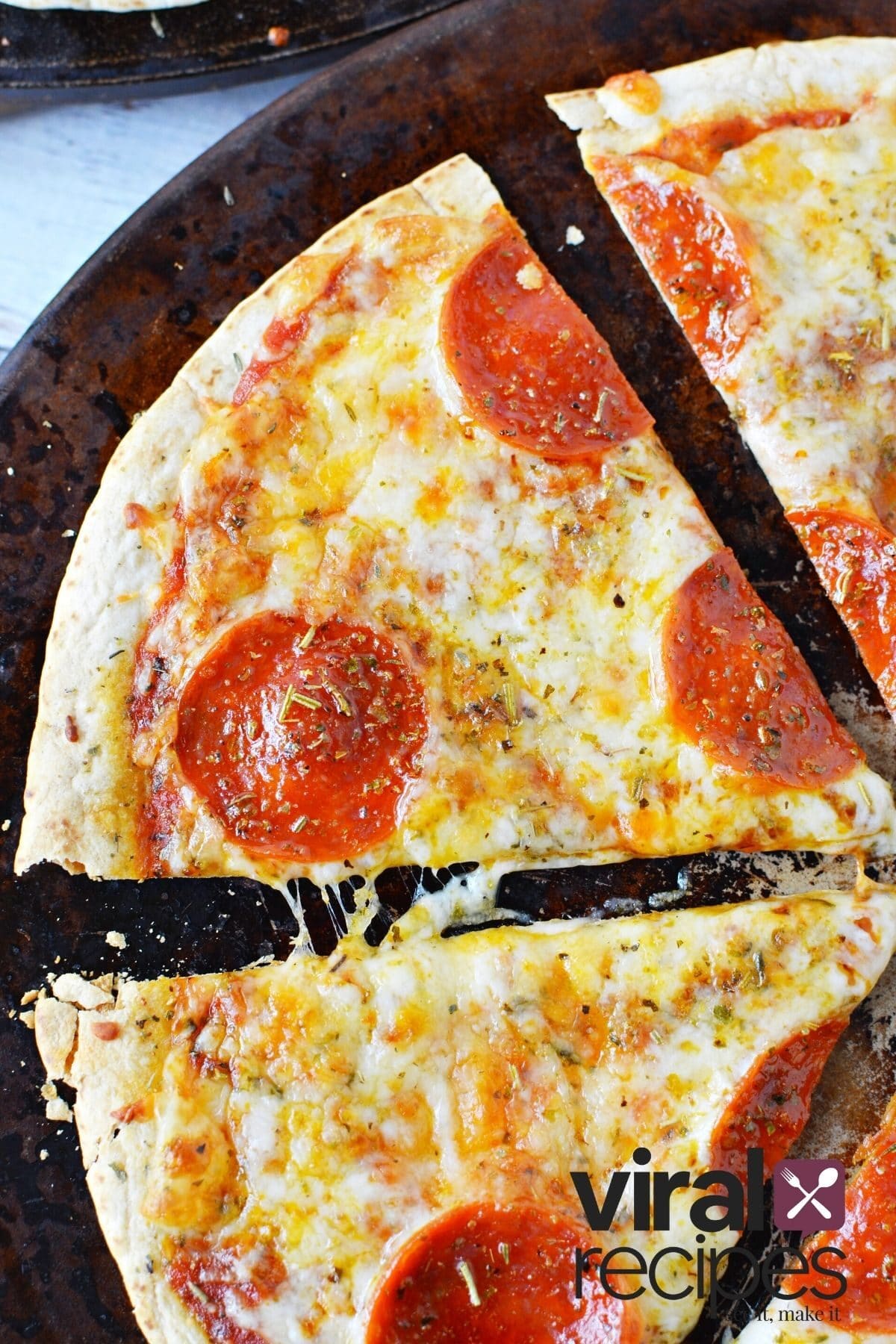 bar pizza being cut into a slice.