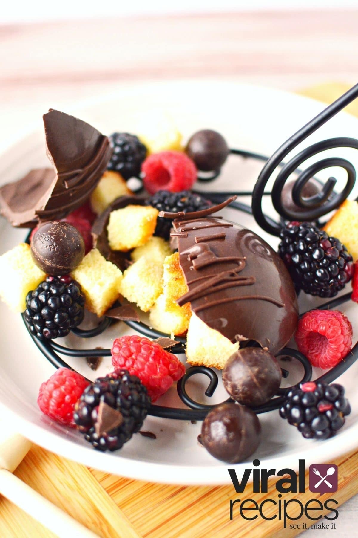 fruit and cake inside a chocolate shell pinata.