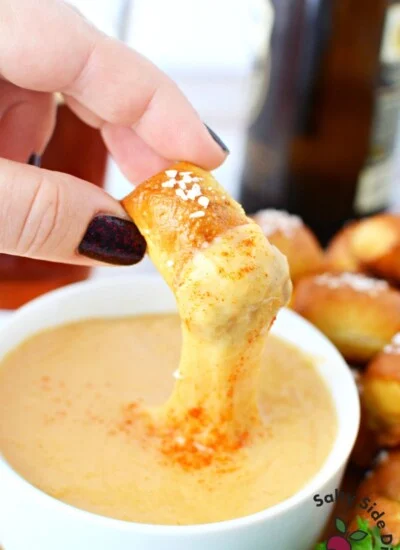 dip soft pretzel into beer cheese.