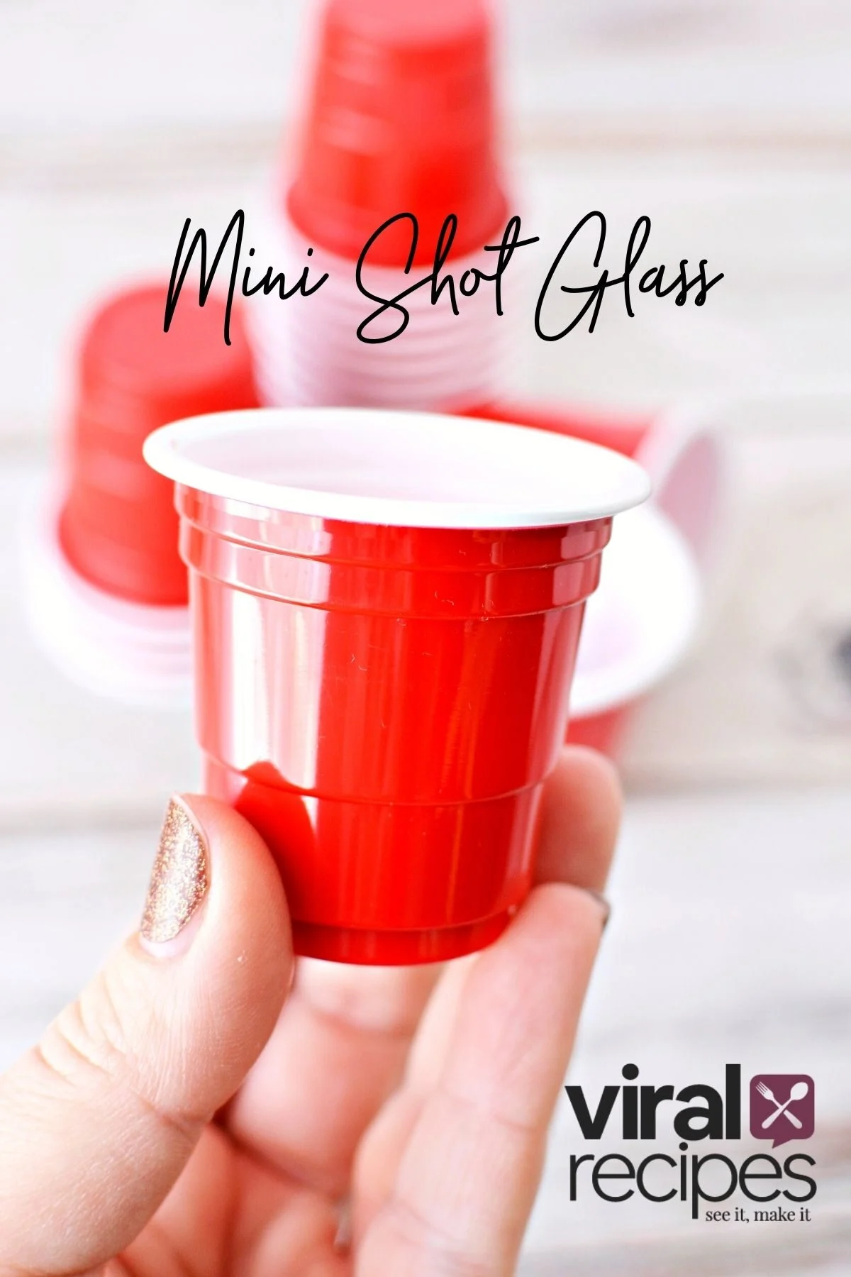 holding a red solo mini shot glass.
