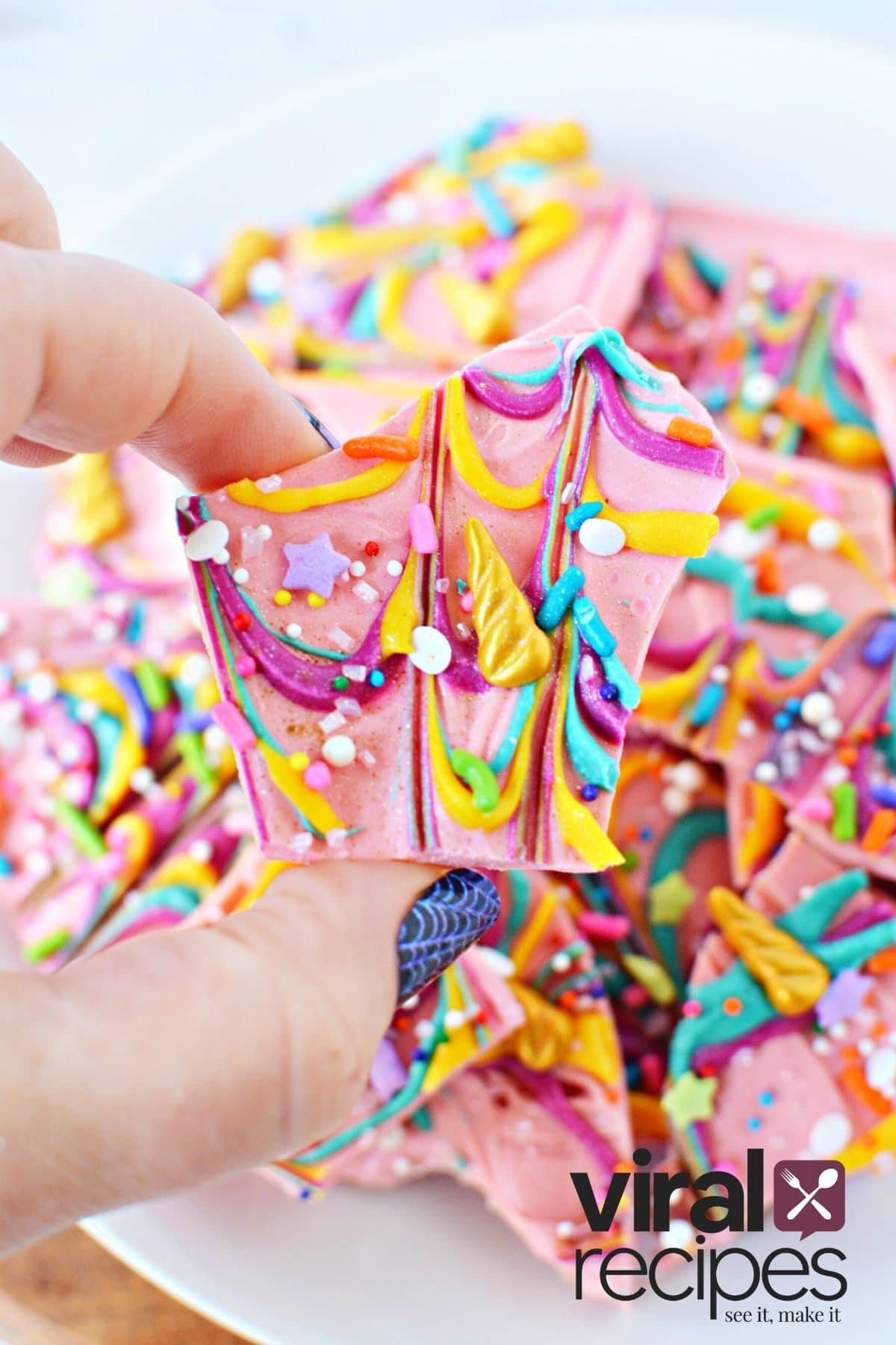 holding a piece of tiktok unicorn bark.