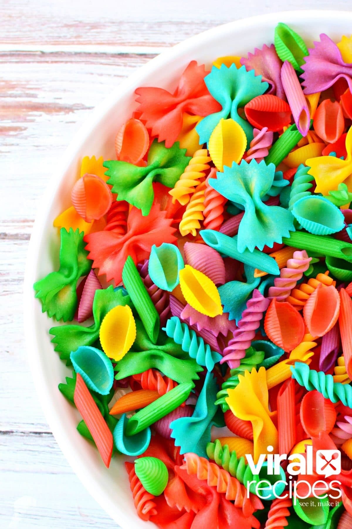 colored pasta in a white bowl.