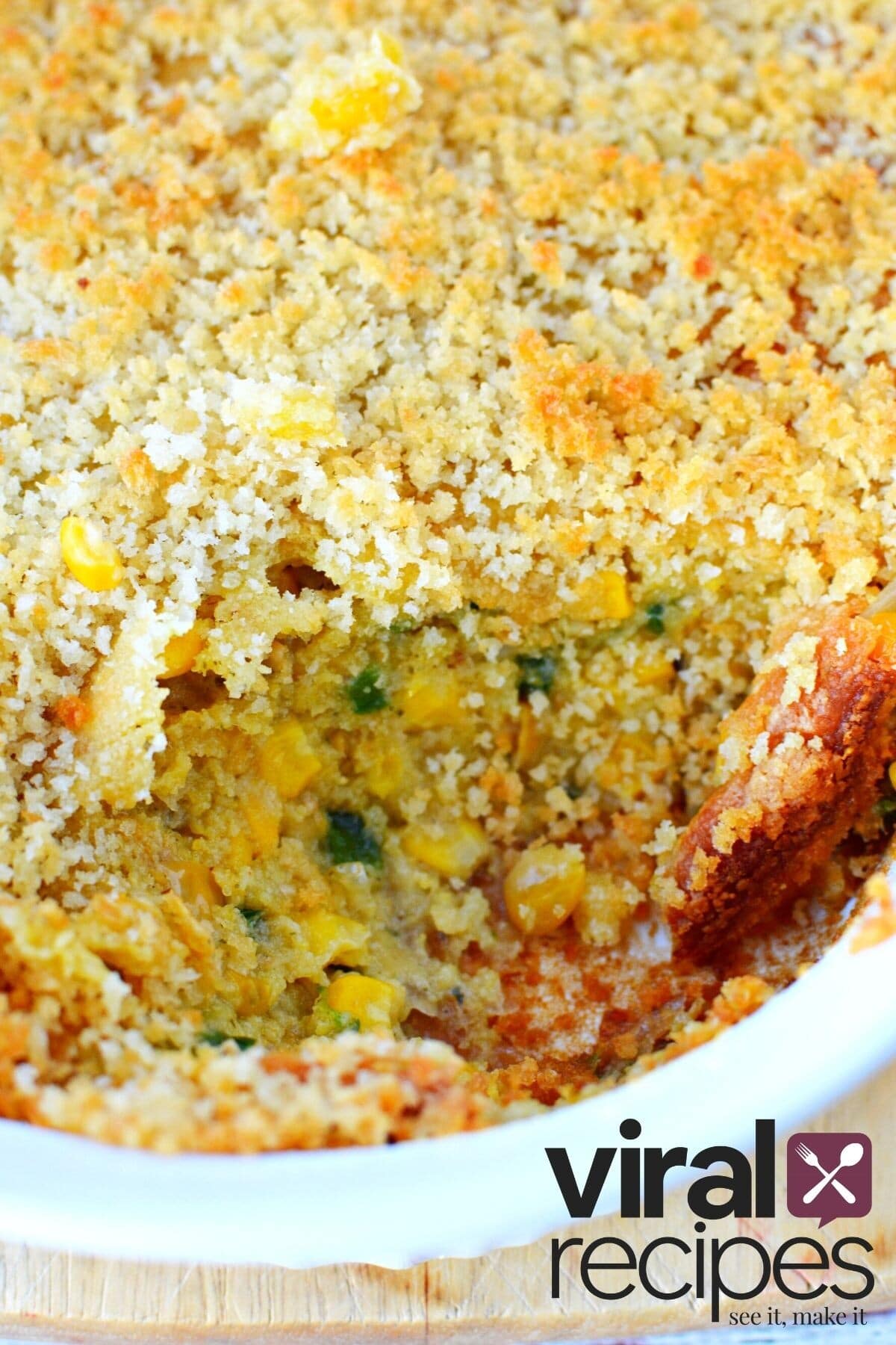 scoop of jalapeno corn casserole out of a white dish.