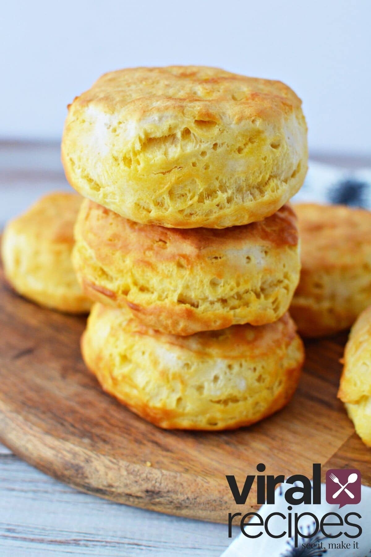 canned biscuits in air fryer stacked up high.