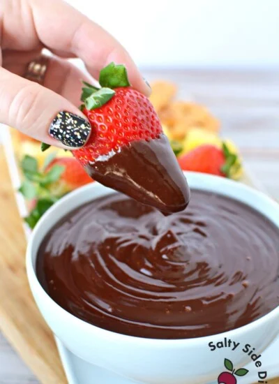 dipping strawberrie in chocolate ganache.