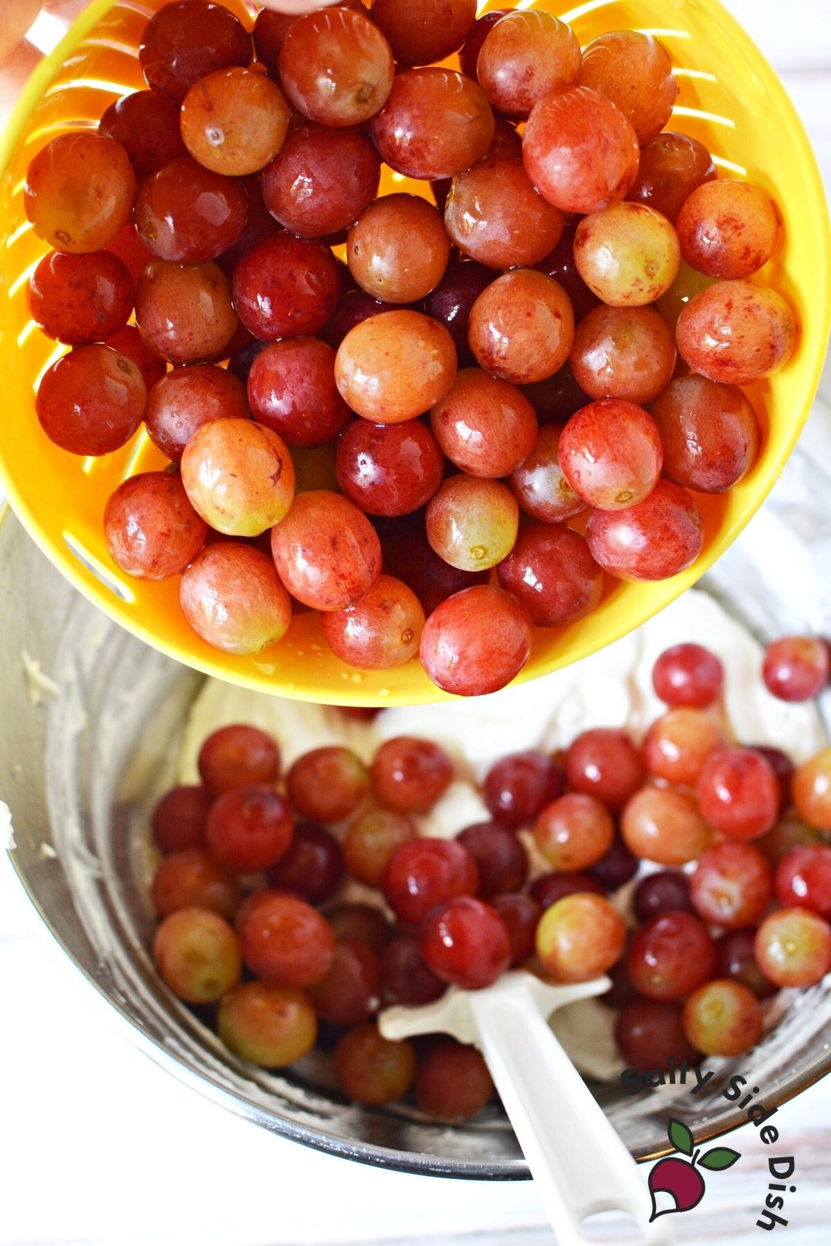 pouring grapes into a bowl.