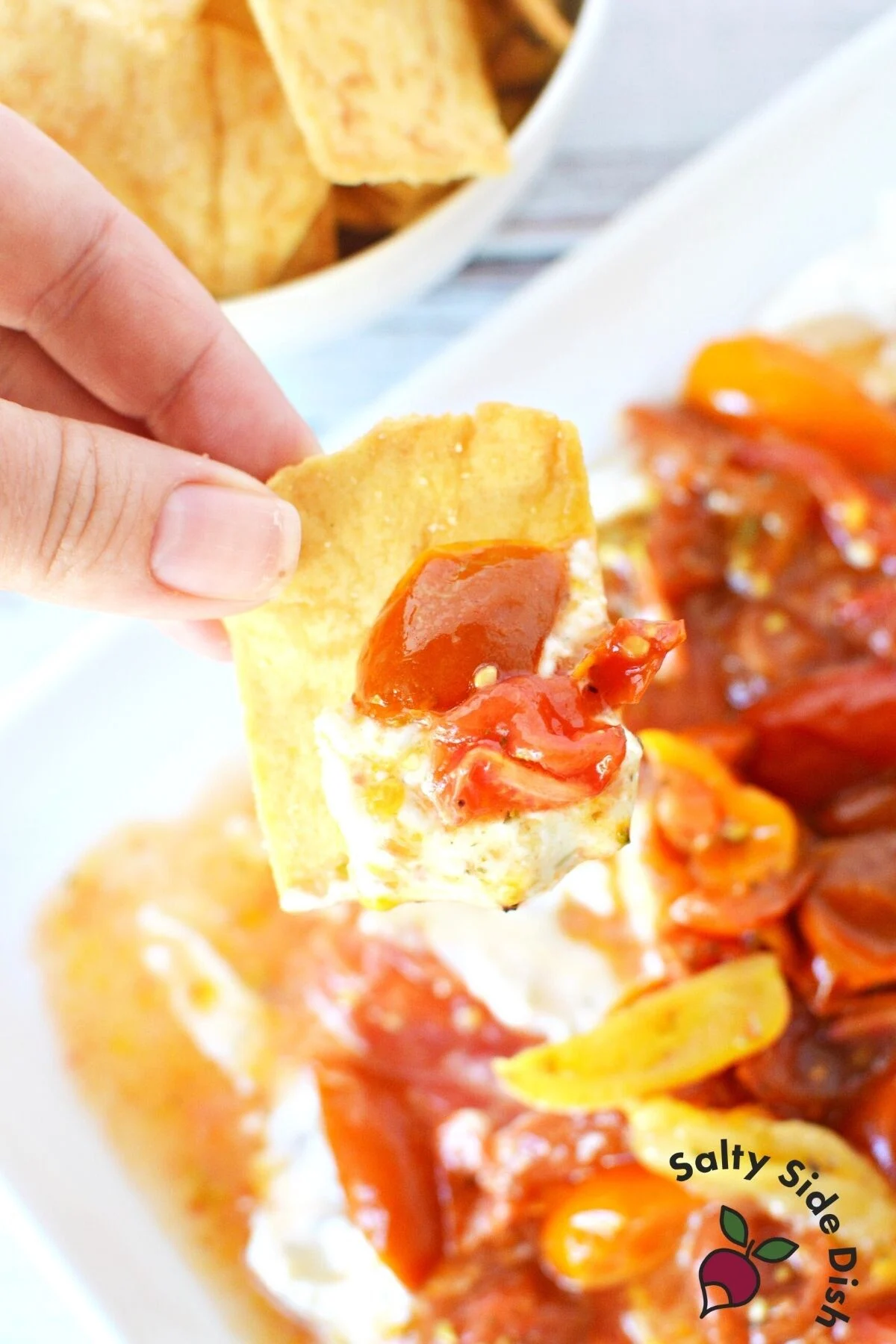 cherry tomato and cheese mixture on a homemade pita chip.