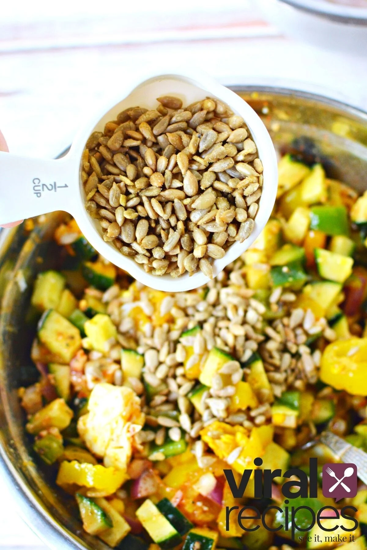 sunflower seeds in a measuring cup.