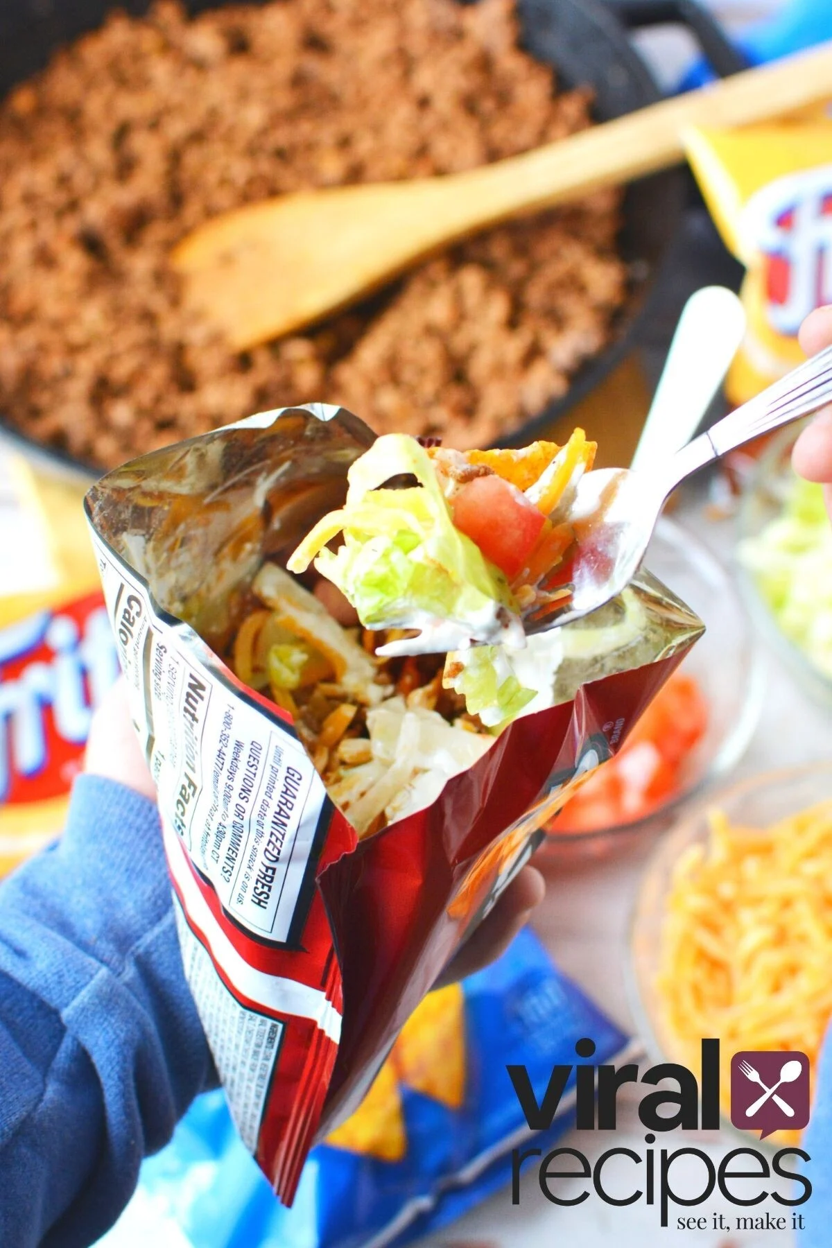 fork full of meat, lettuce and tomatoes.