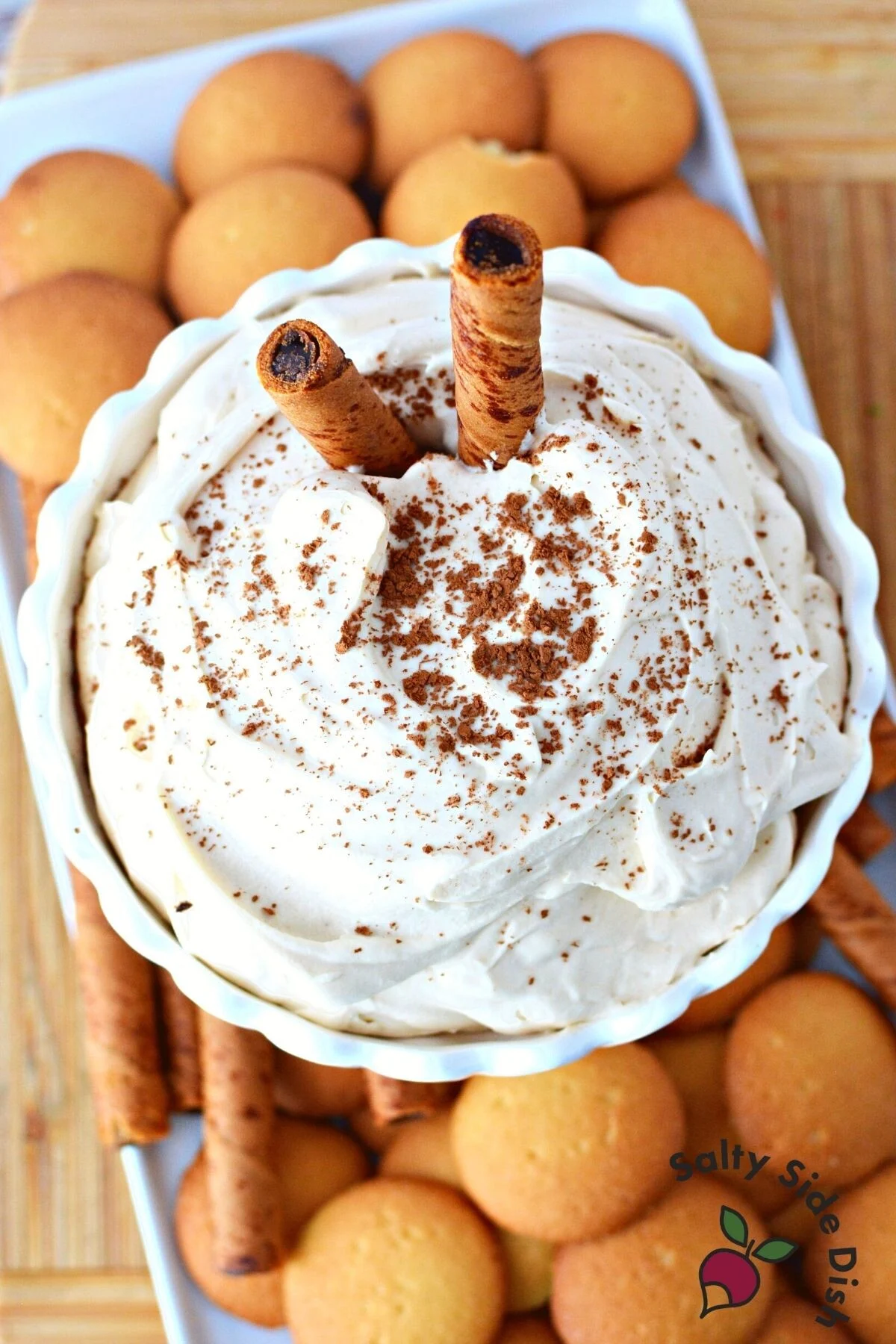 tiramisu dip on a plate surrounded by cookies.