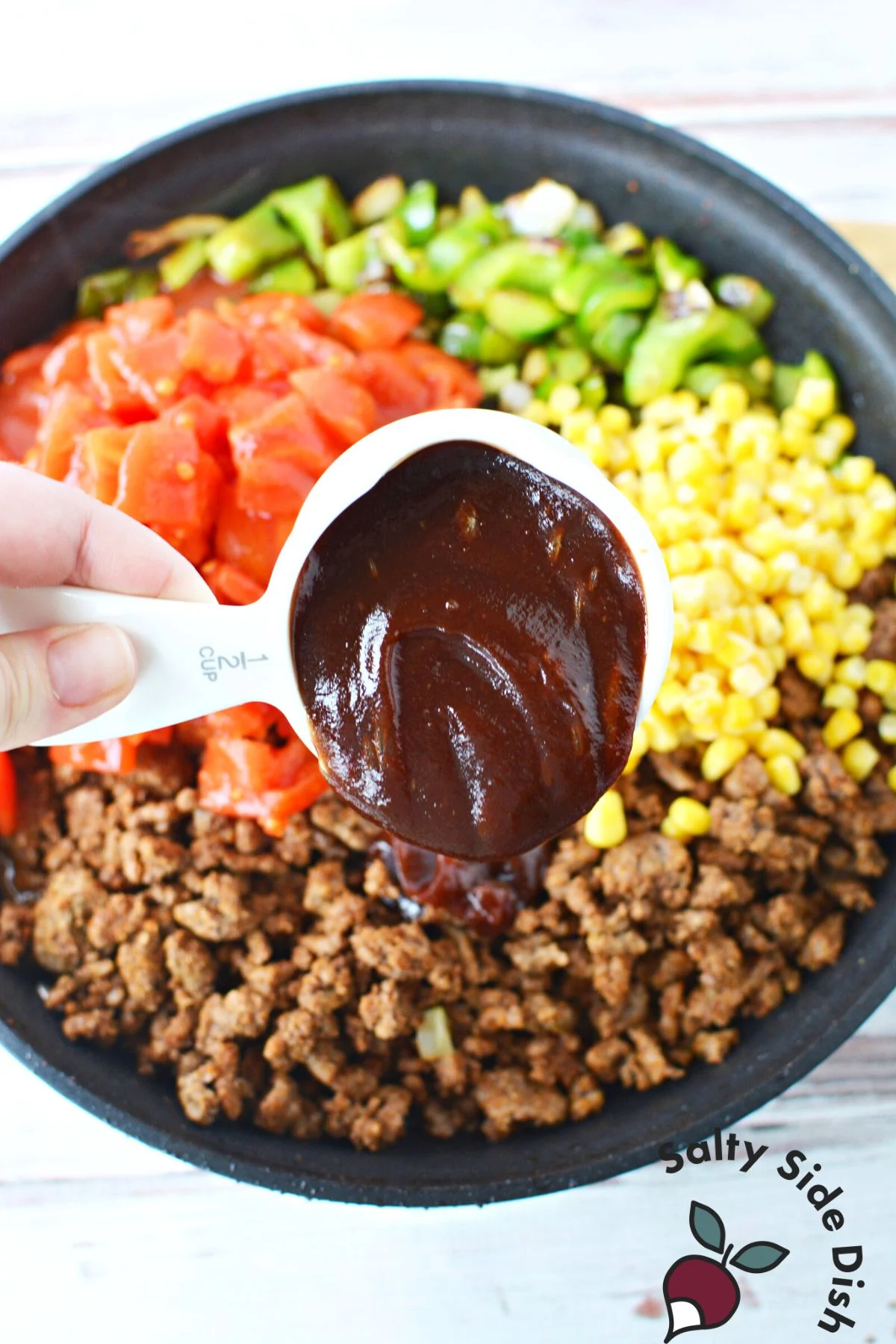 adding bbq sauce to skillet.