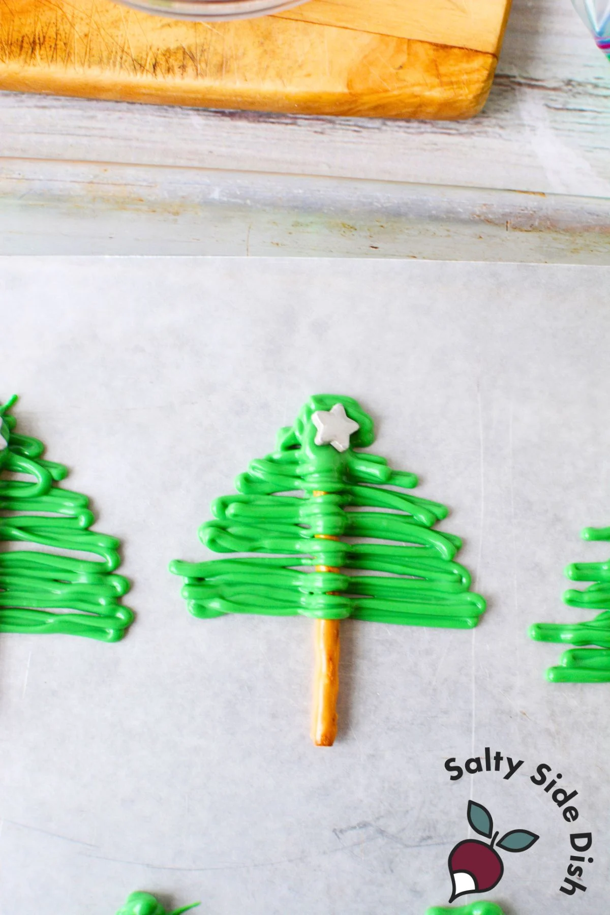 add chocolate on pretzel rods and put on star before it hardens.