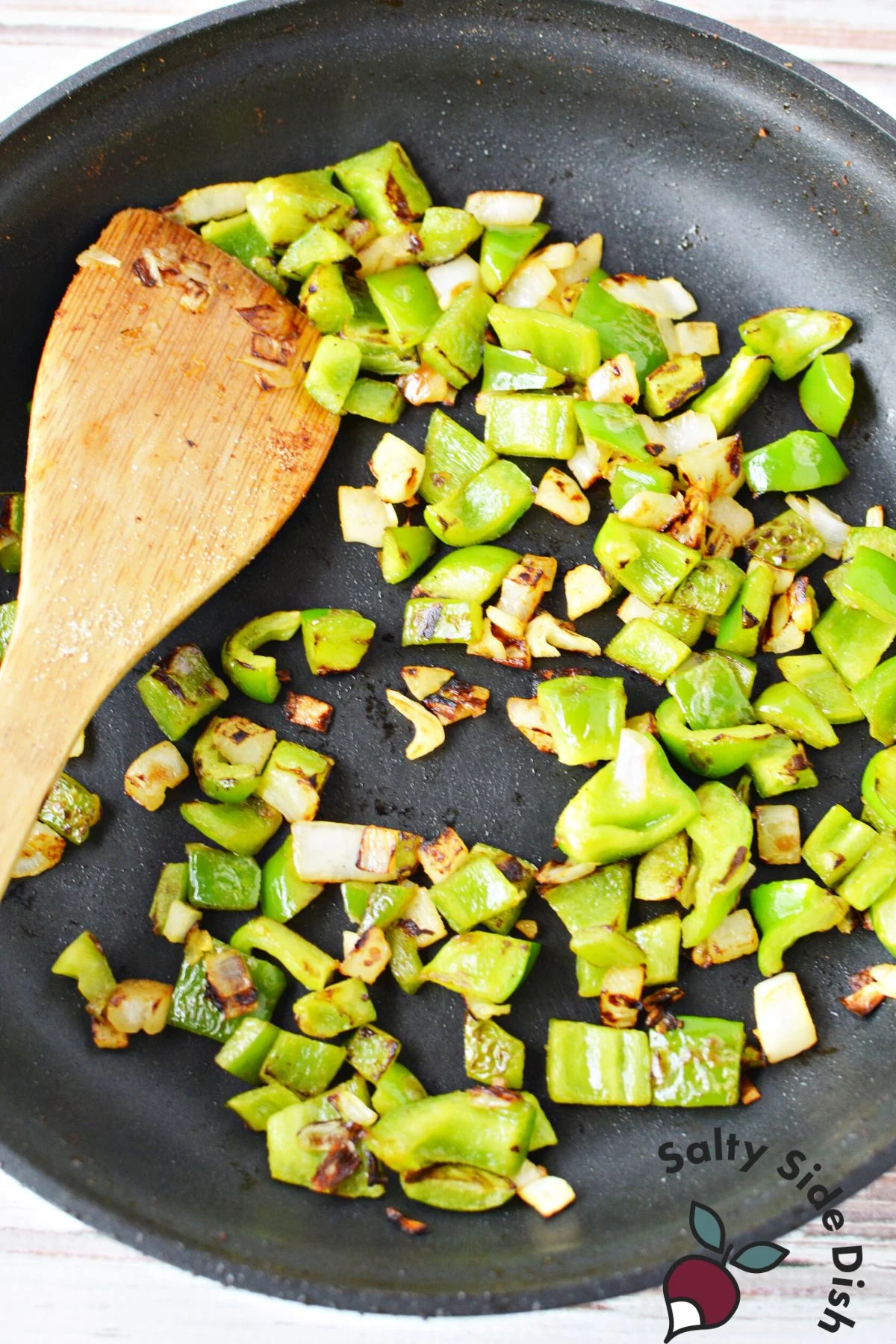 frying up green onions in a skillet.