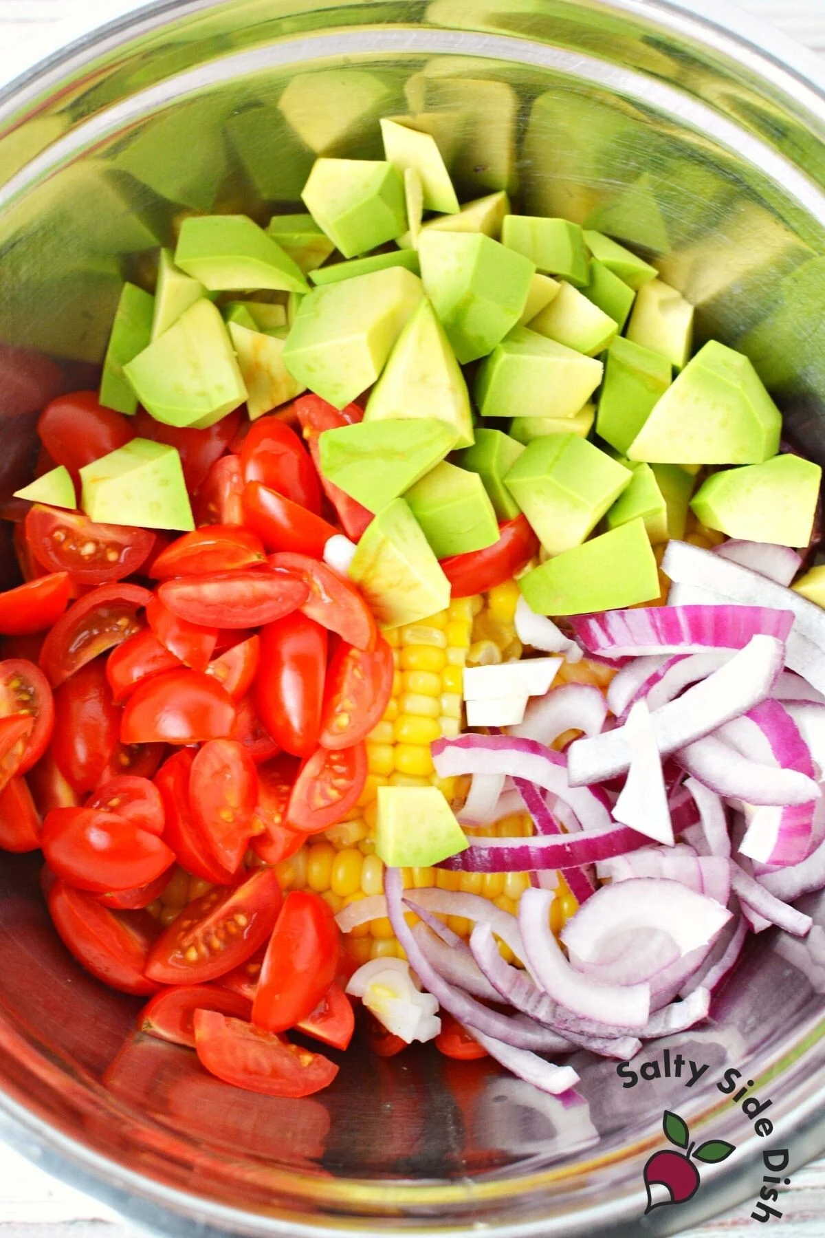 salad recipe ingredients in a silver bowl.