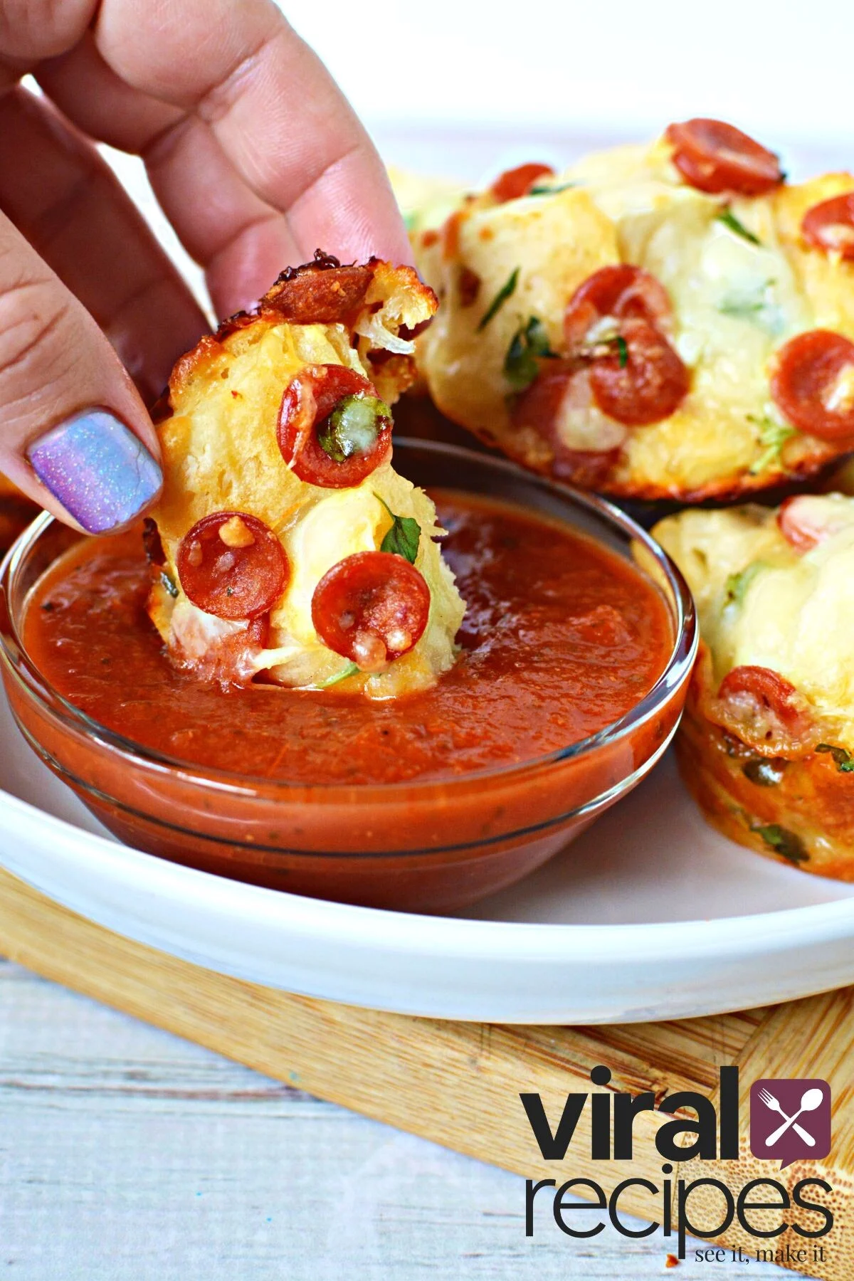 mini pizza dipping into marinara sauce.