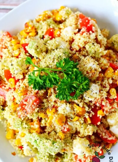 easy summer couscous salad on a white plate.