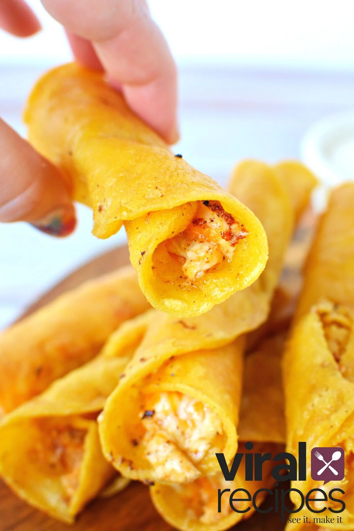 holding a chicken buffalo taquito.