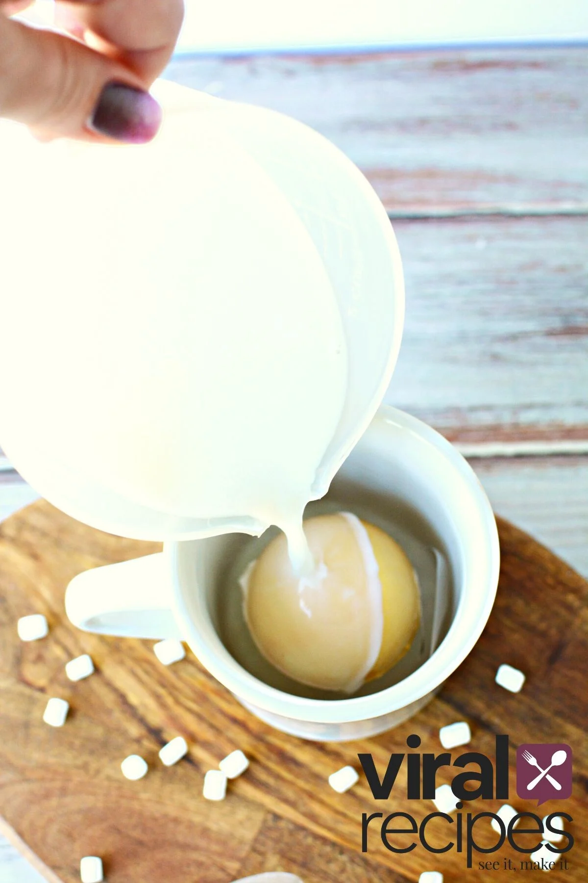 pour milk over hot chocolate bomb.