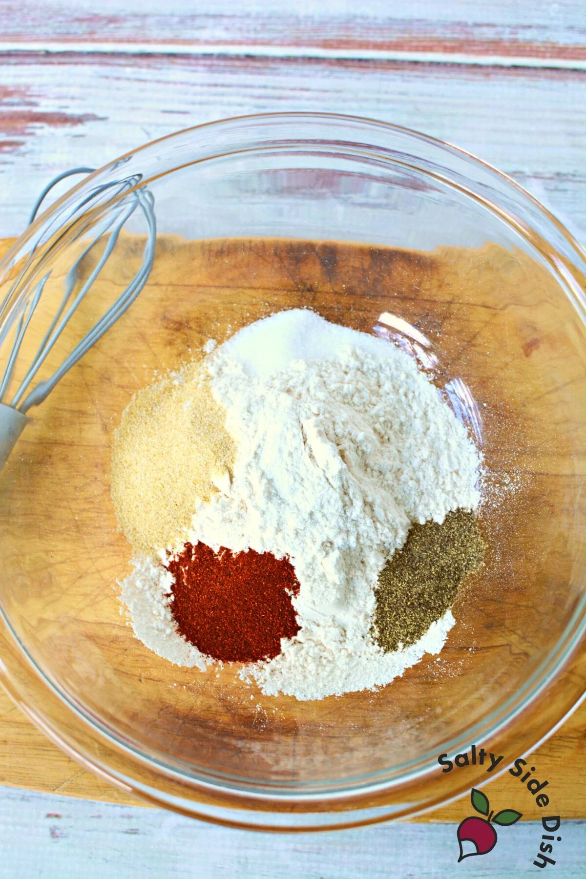adding all flour and seasonings to a bowl.