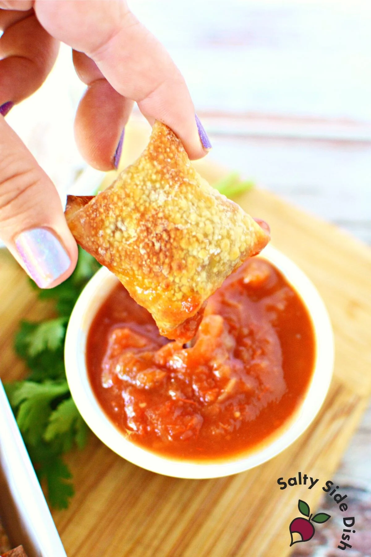 tiktok taco wonton recipe dipped in salsa.