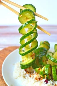 spiral cucumbers being held by chopsticks.
