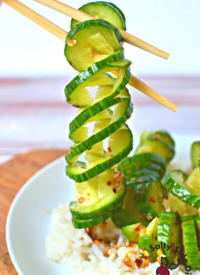 spiral cucumbers being held by chopsticks.
