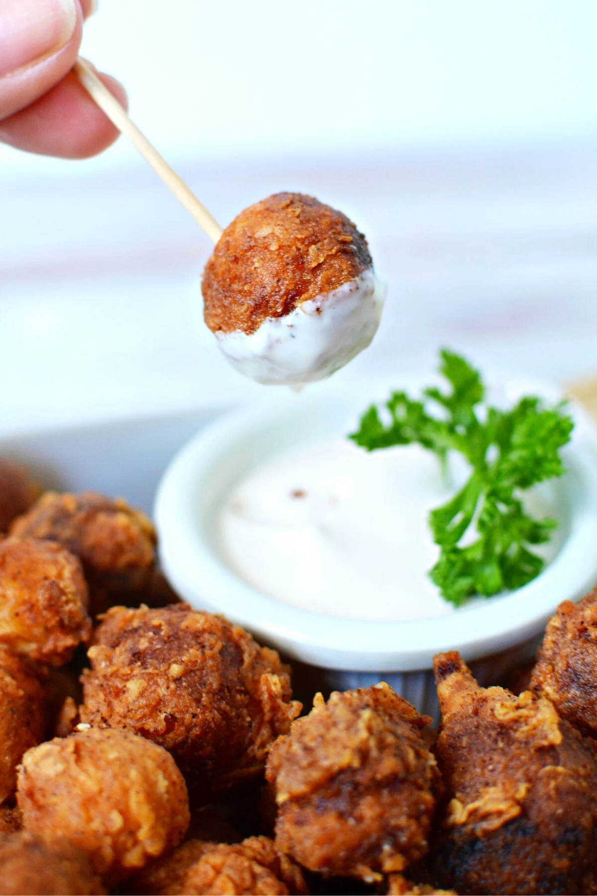 ranch dipping sauce on a fried onion.