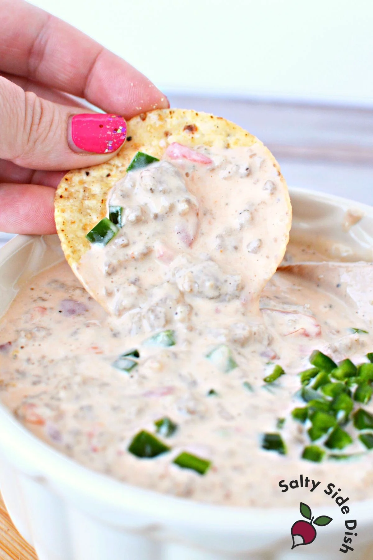 tortilla chip in cheesy dip.