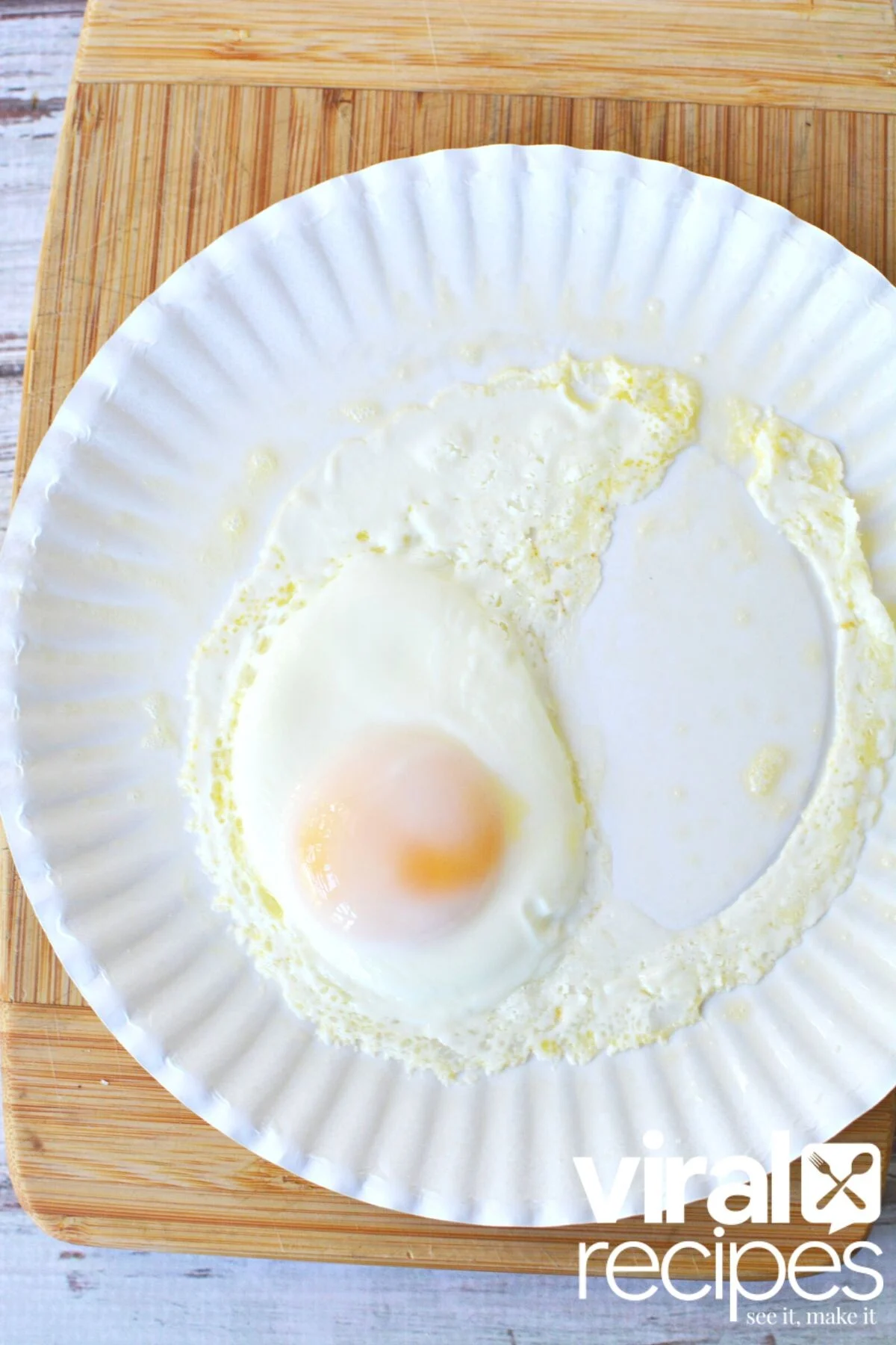 cooking an egg on a paper plate.