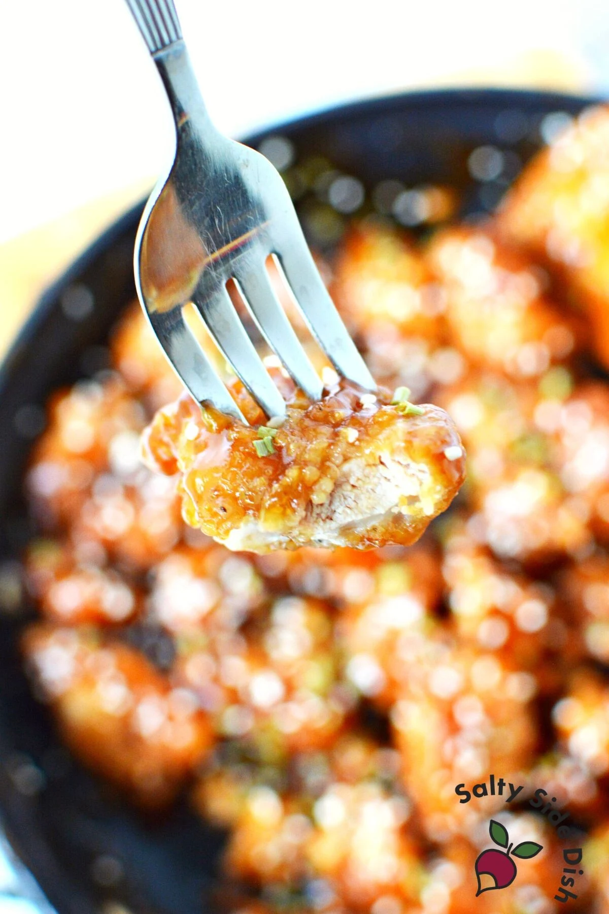 sesame chicken on a fork.
