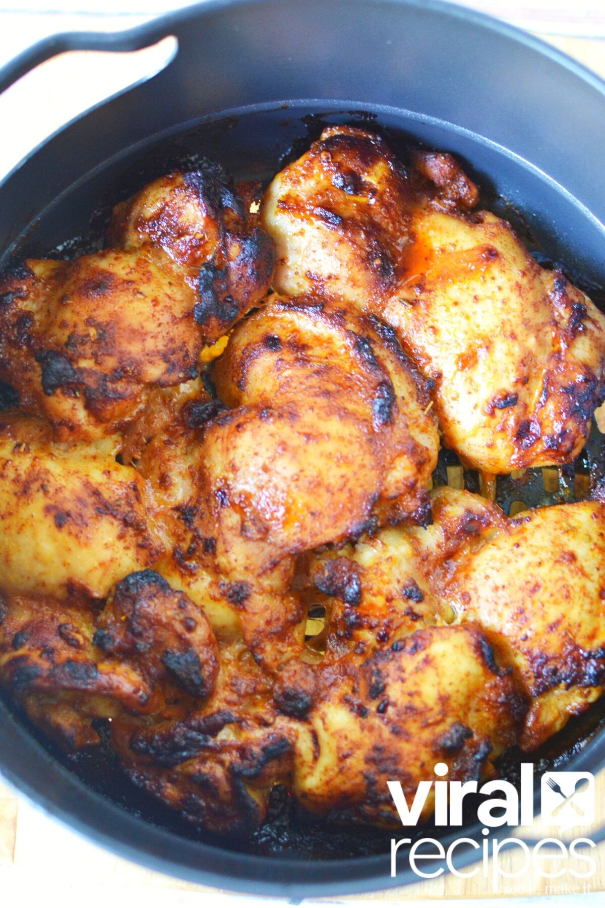 chicken thighs in air fryer basket.