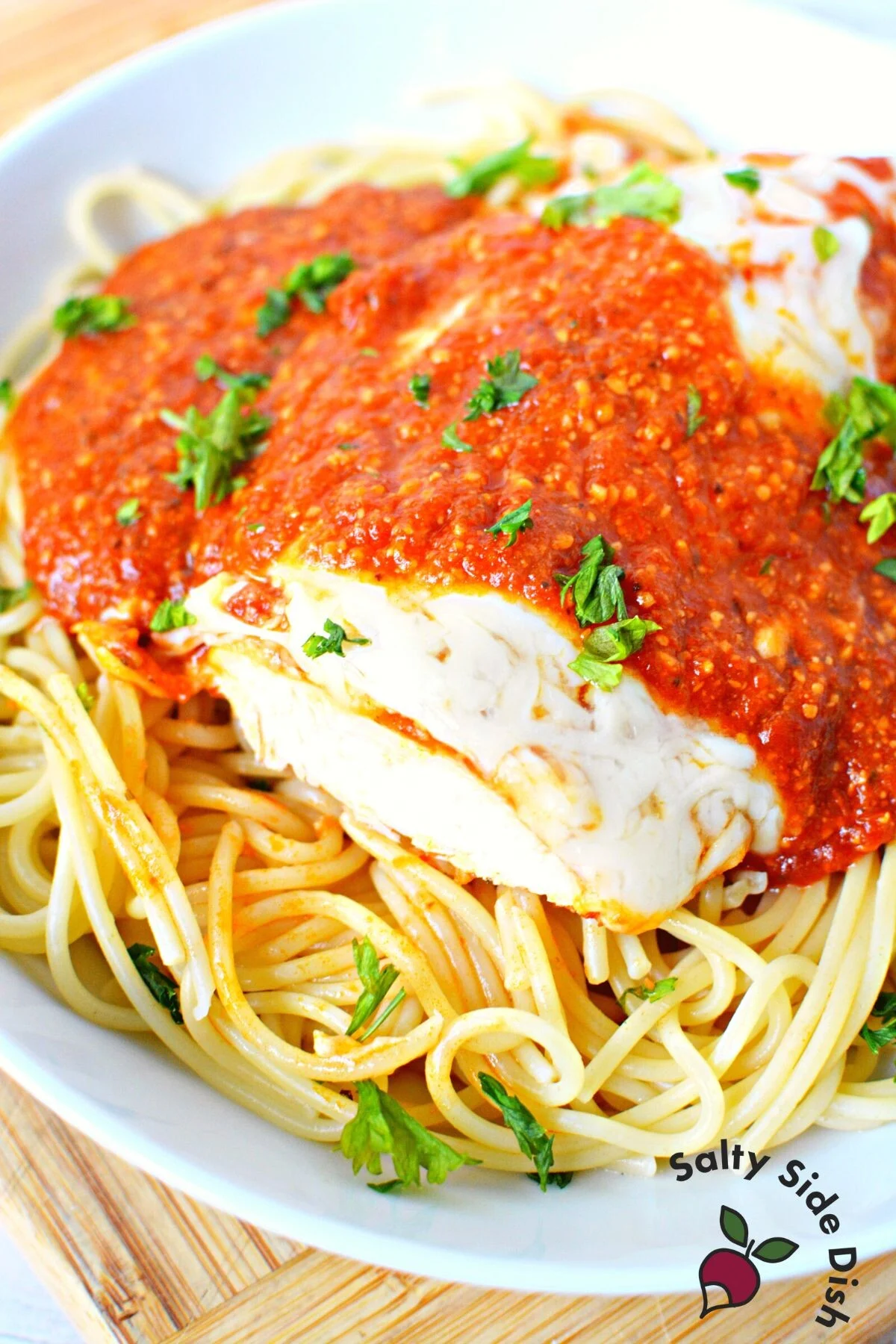best chicken parmesan recipe on a plate of spaghetti.