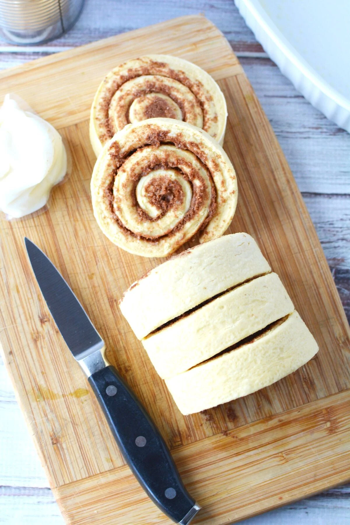 cutting up cinnamon rolls.